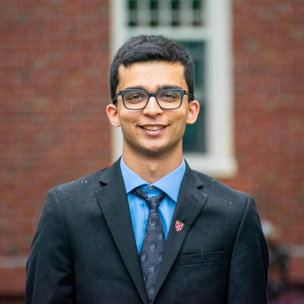 Sajeev standing in front of brick building