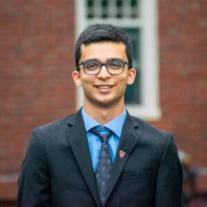 Sajeev standing in front of brick building