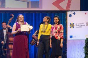 Annabelle Rayson, left, receives a third prize award for from Mariya Lyubenova, President of the EUCYS Jury (judging panel) and Anna Panagopoulou, director of European Research Area & Innovation at the Research and Innovation Directorate General of the European Commission during the 2022 European Union Contest for Young Scientists (EUCYS) awards ceremony in Leiden, Netherlands, September 17, 2022