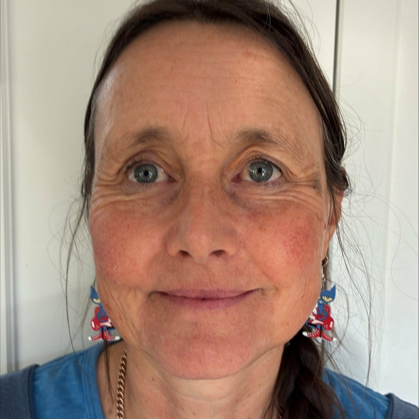 Youth Science Canada - Woman with earrings and blue shirt