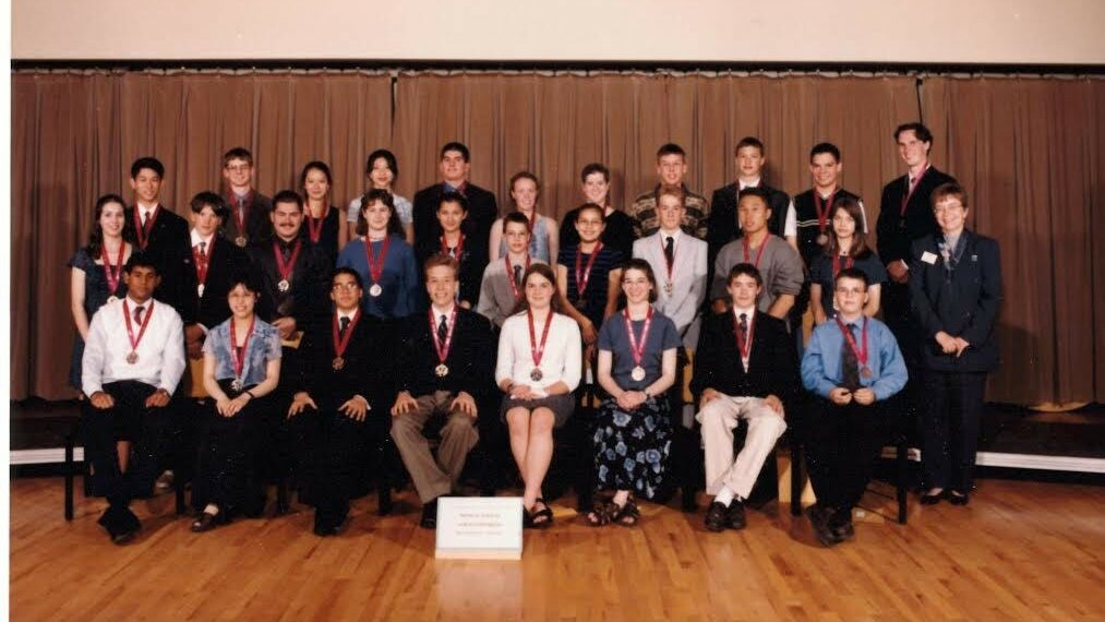 Group of young students and mentors on stage at Youth Science Canada event, celebrating the winners of the Best Project Award, emphasizing community engagement and scientific achievement.