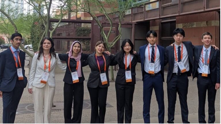 Innovative youth science students at Youth Science Canada event, diverse group of young researchers and innovators outdoors, promoting STEM education and scientific collaboration.